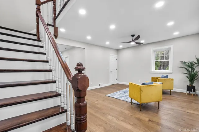 a view of a livingroom with wooden floor and furniture