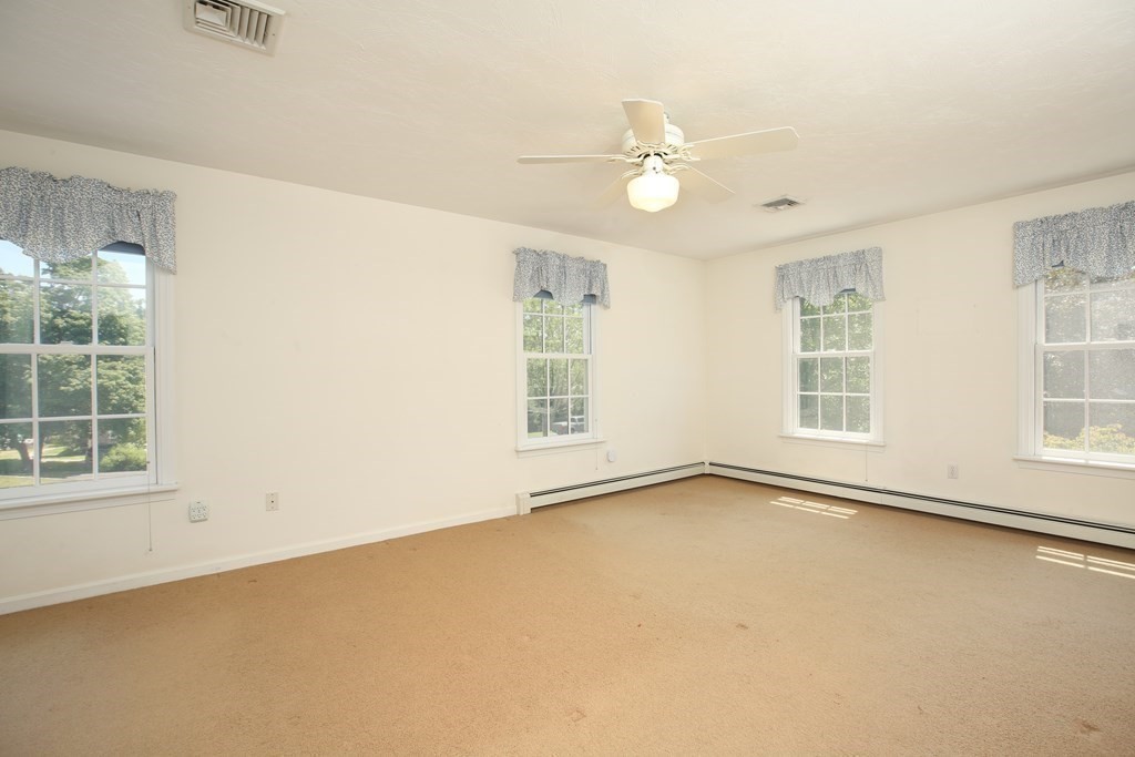 5 Charles Everett Way Hingham, MA 02043 - Photo 14 of 27 an empty room with windows and chandelier fan
