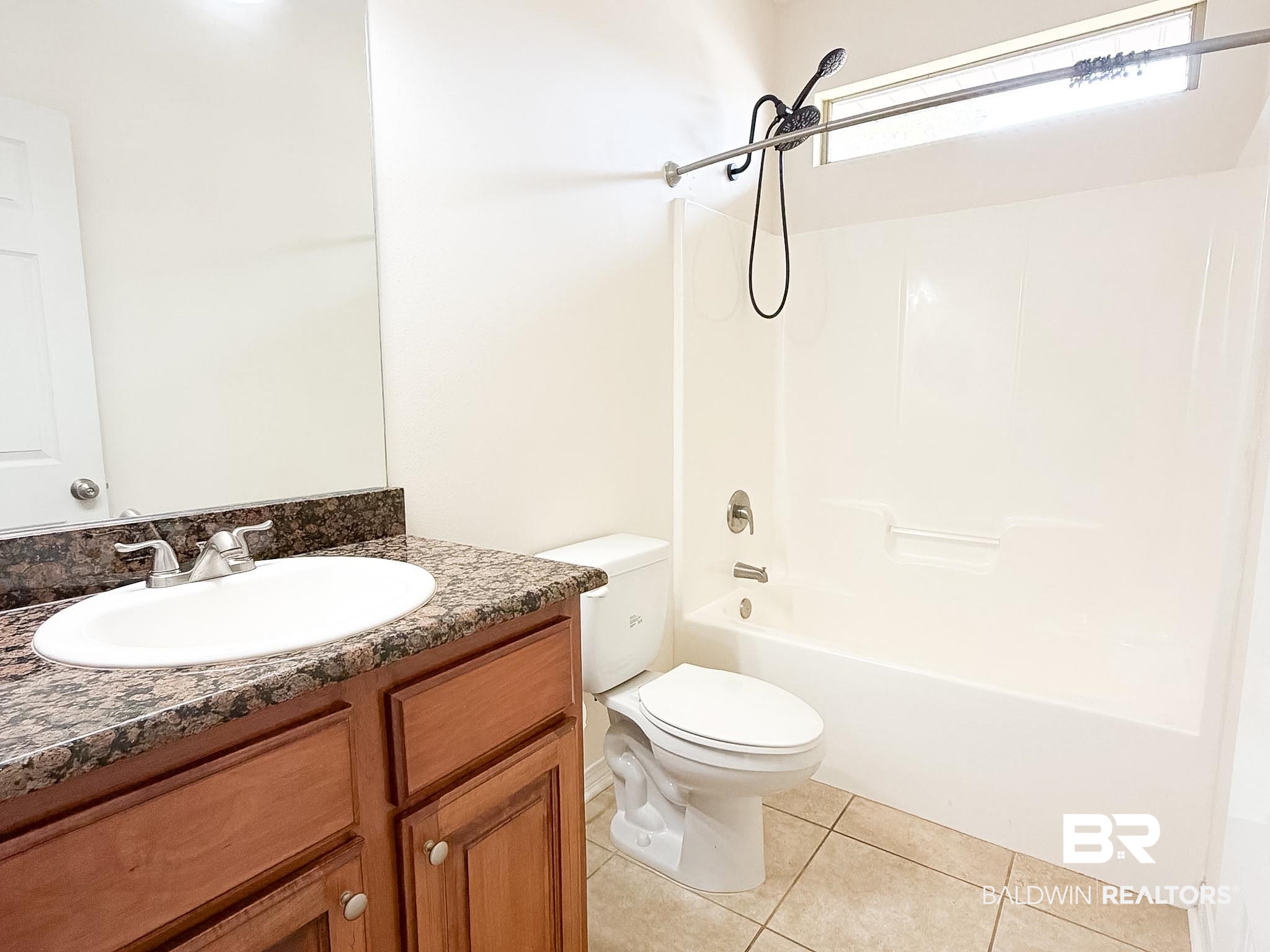 7332 Raintree Lane Gulf Shores, AL 36542 - Photo 18 of 21 Bathroom featuring vanity, shower / bath combination, and light tile patterned floors