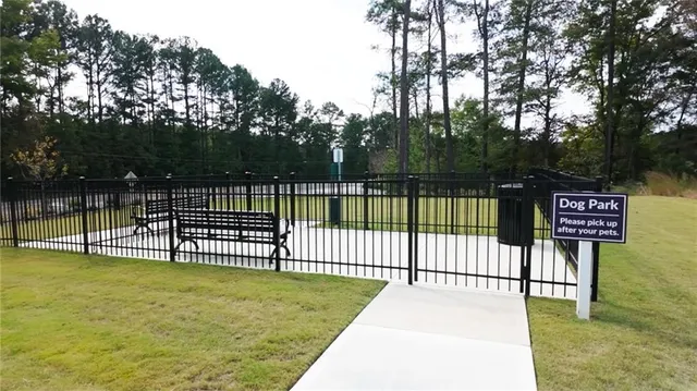 a view of a park with iron fence