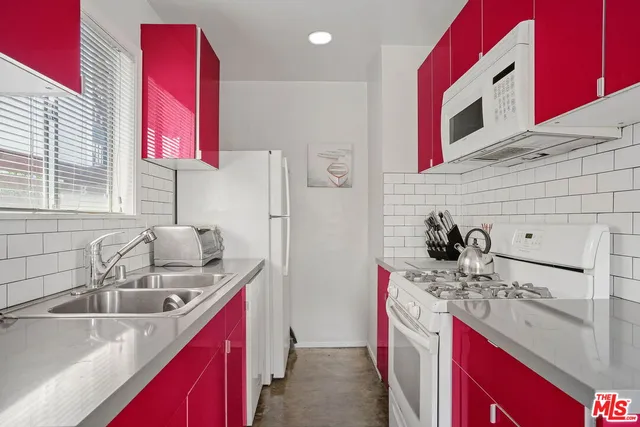 a kitchen with a sink stove top oven and cabinets