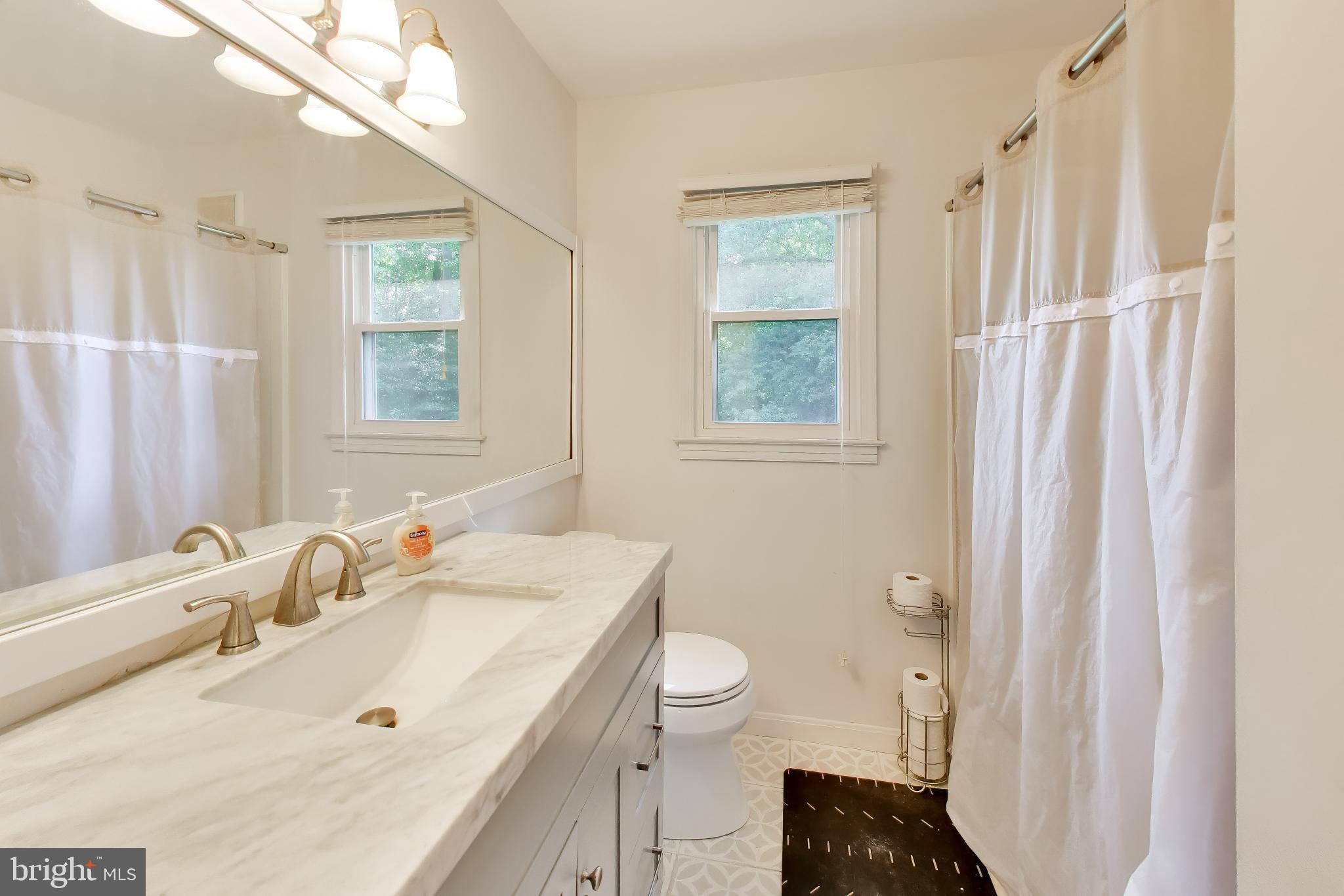 3240 Juniper Lane Huntingtown, MD 20639 - Photo 14 of 48 a bathroom with a granite countertop sink toilet and shower