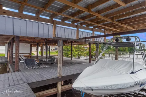 a view of a balcony with wooden floor and outdoor seating