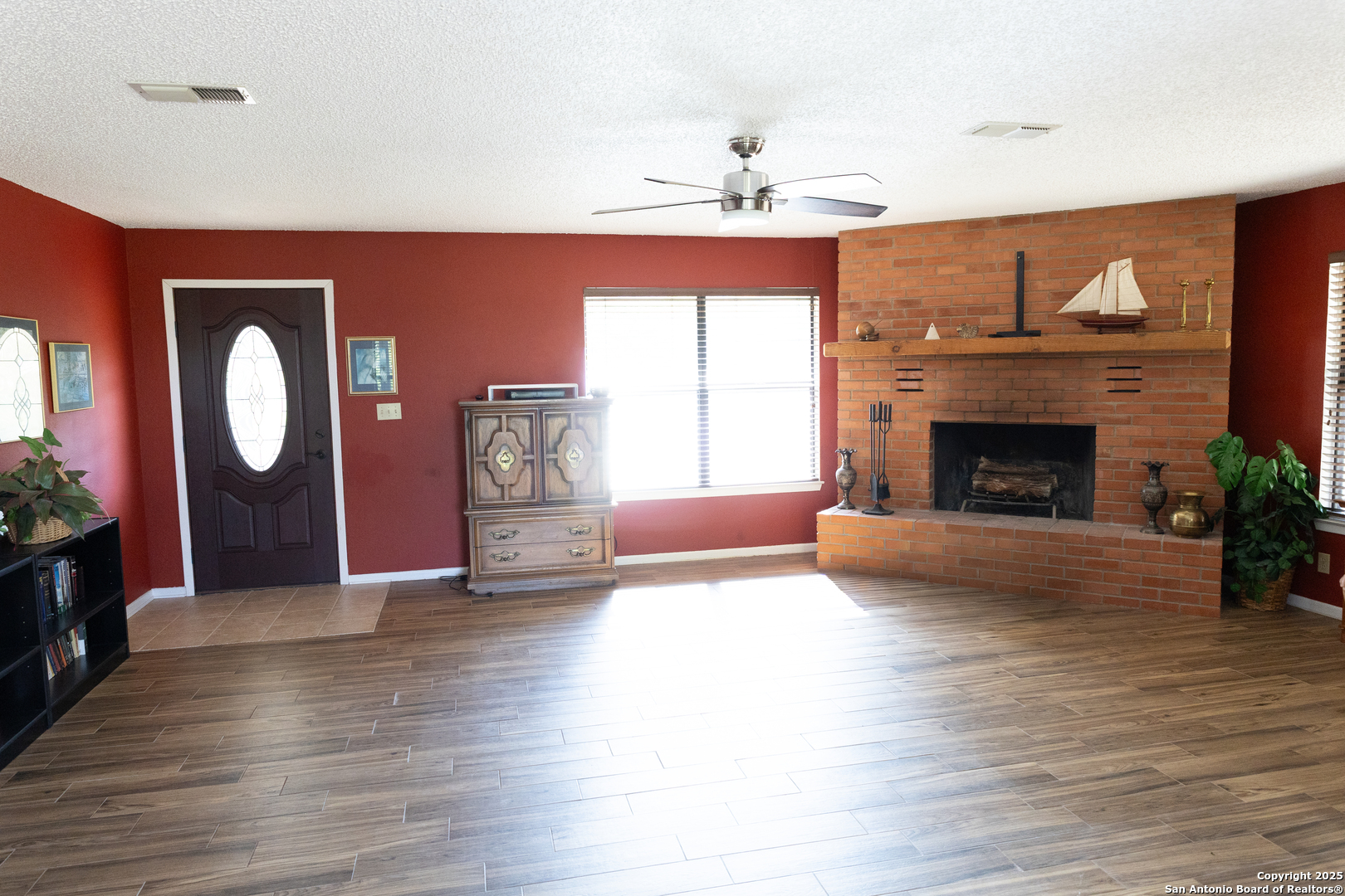 1318 Kc 3151 Junction, TX 76849 - Photo 7 of 25 a view of an empty room with wooden floor fireplace and a window