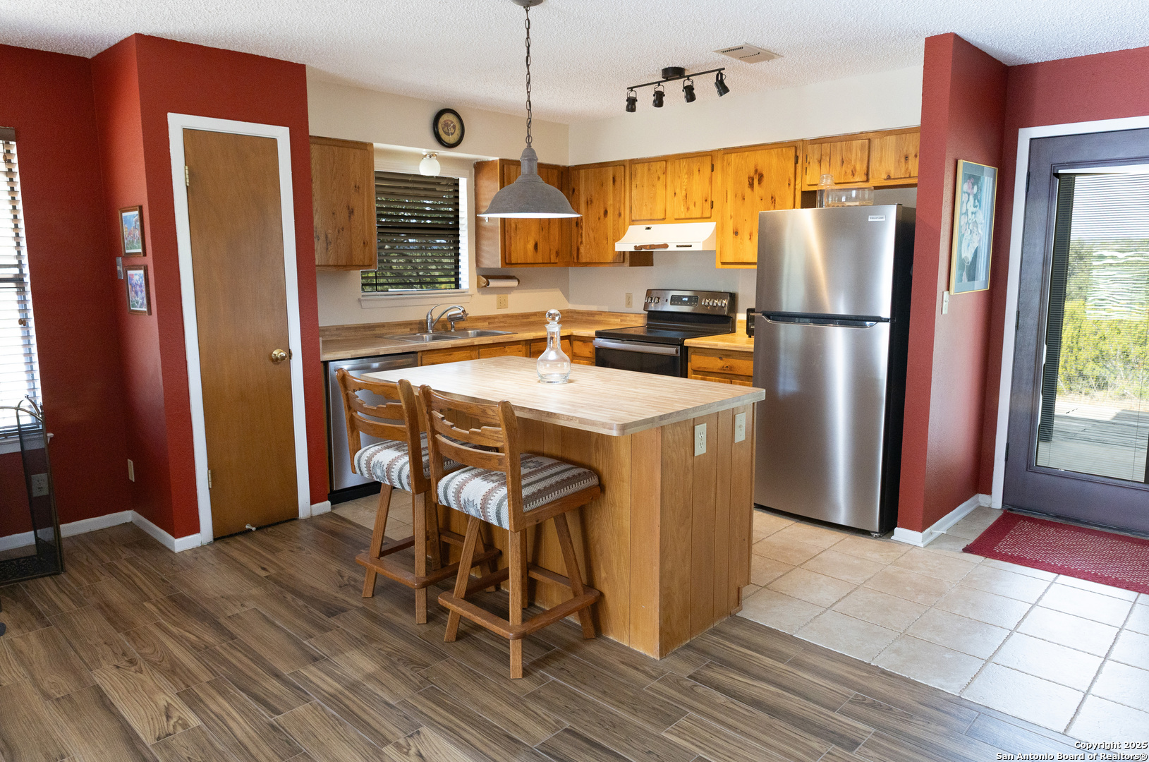 1318 Kc 3151 Junction, TX 76849 - Photo 8 of 25 a kitchen with stainless steel appliances granite countertop a refrigerator a stove a sink dishwasher and a refrigerator with wooden floor