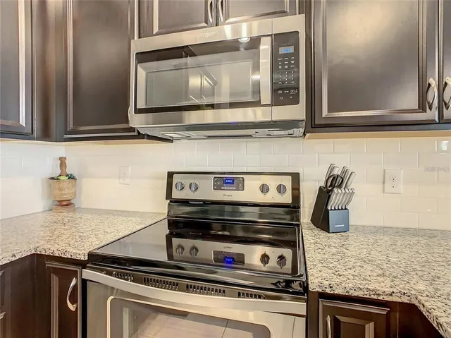a kitchen with center island a sink stainless steel appliances and cabinets