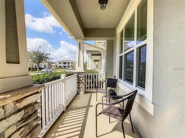a view of a chairs and table in the balcony