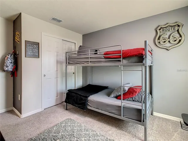 a bedroom with a bed and a night stand