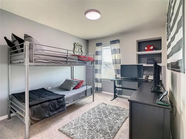 a bedroom with a large bed and a window