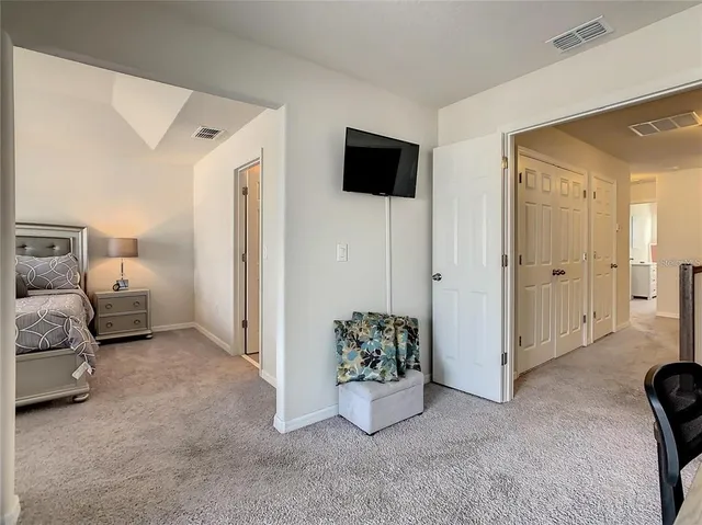 a bedroom with a bed and a large window
