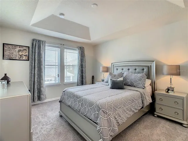a bathroom with a double vanity sink a toilet and a mirror