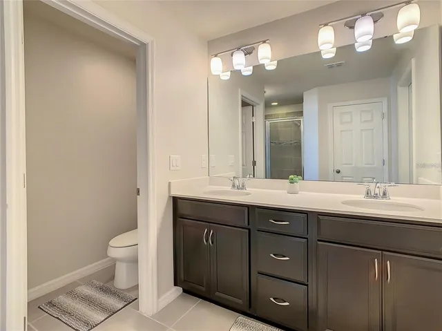 a living room with furniture and a lamp