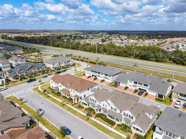 an aerial view of residential houses with outdoor space