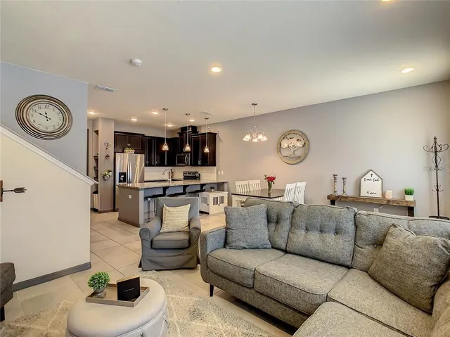 a living room with furniture and a clock