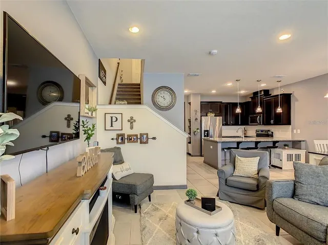 a living room with furniture and a clock