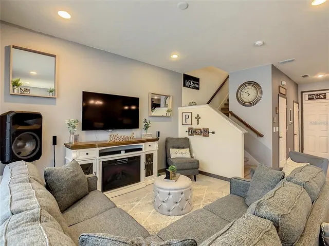 a living room with furniture and a flat screen tv