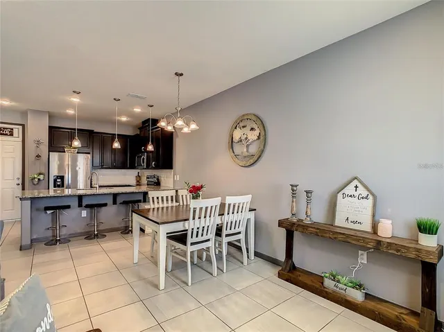 a kitchen with granite countertop a refrigerator and a sink