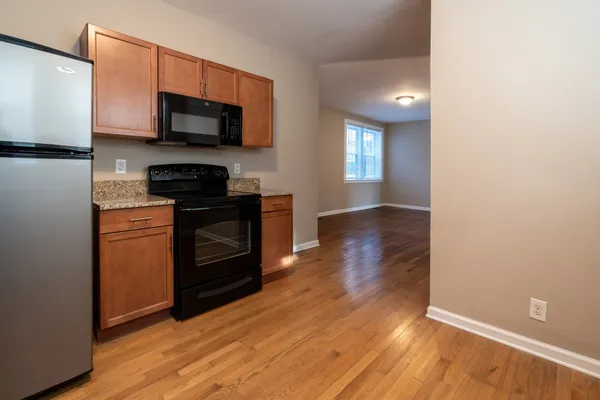 a kitchen with stainless steel appliances a stove a microwave and sink