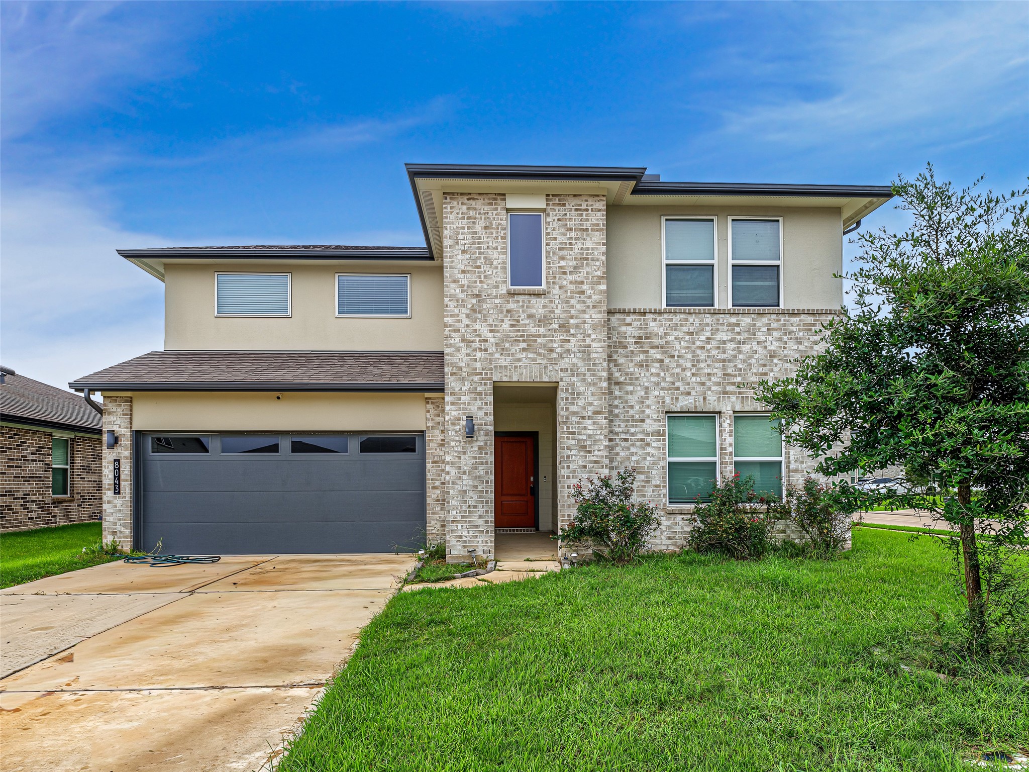 8043 Milam Lane Rosharon, TX 77583 - Photo 1 of 41 This impressive two-story home boasts a sophisticated blend of light brick and smooth stucco, exuding contemporary charm and curb appeal.