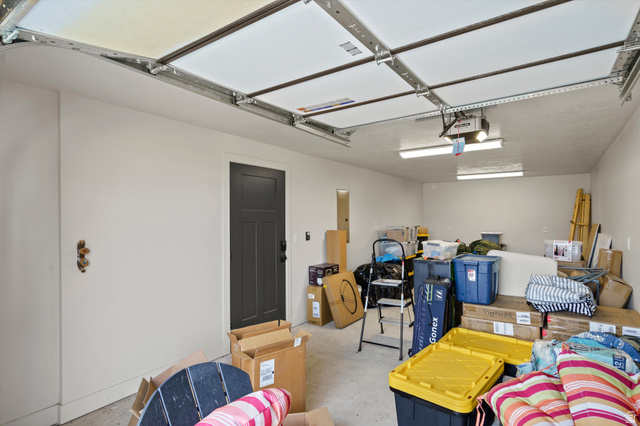 4499 North Seven Bridges Road, Unit 9 Eden, UT 84310 - Photo 46 of 65 Attached garage with a panel garage door, built-in lighting, and a dark-paneled interior door