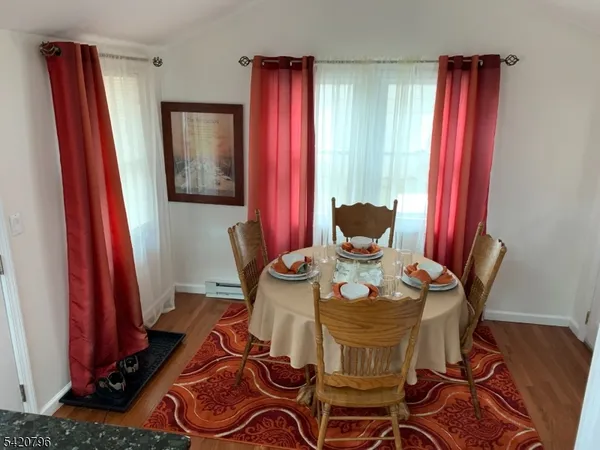 a view of a dining room with furniture and a window