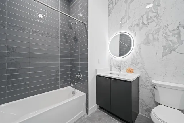 a bathroom with a sink a toilet and bathtub