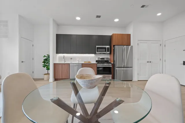 a kitchen with stainless steel appliances granite countertop a refrigerator a microwave a sink and a stove