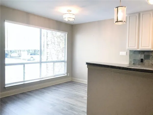a kitchen with a window wooden floor and a window
