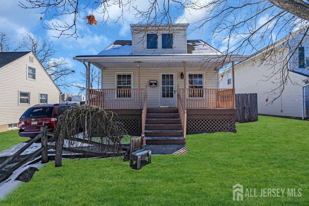 a view of a house with a yard and sitting area