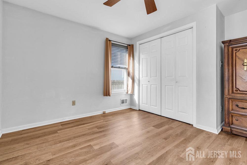 720 Voorhees Avenue Middlesex, NJ 08846 - Photo 15 of 28 a view of an empty room with wooden floor and a window