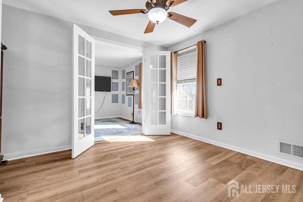 720 Voorhees Avenue Middlesex, NJ 08846 - Photo 16 of 28 a view of a livingroom with wooden floor and a ceiling fan