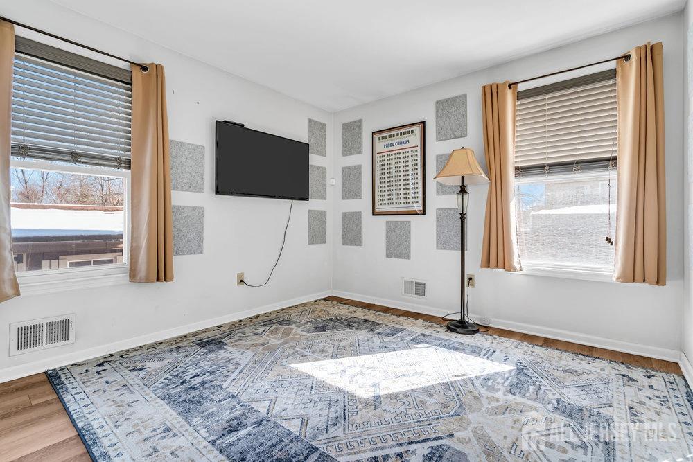 720 Voorhees Avenue Middlesex, NJ 08846 - Photo 18 of 28 a view of a livingroom with wooden floor and a window