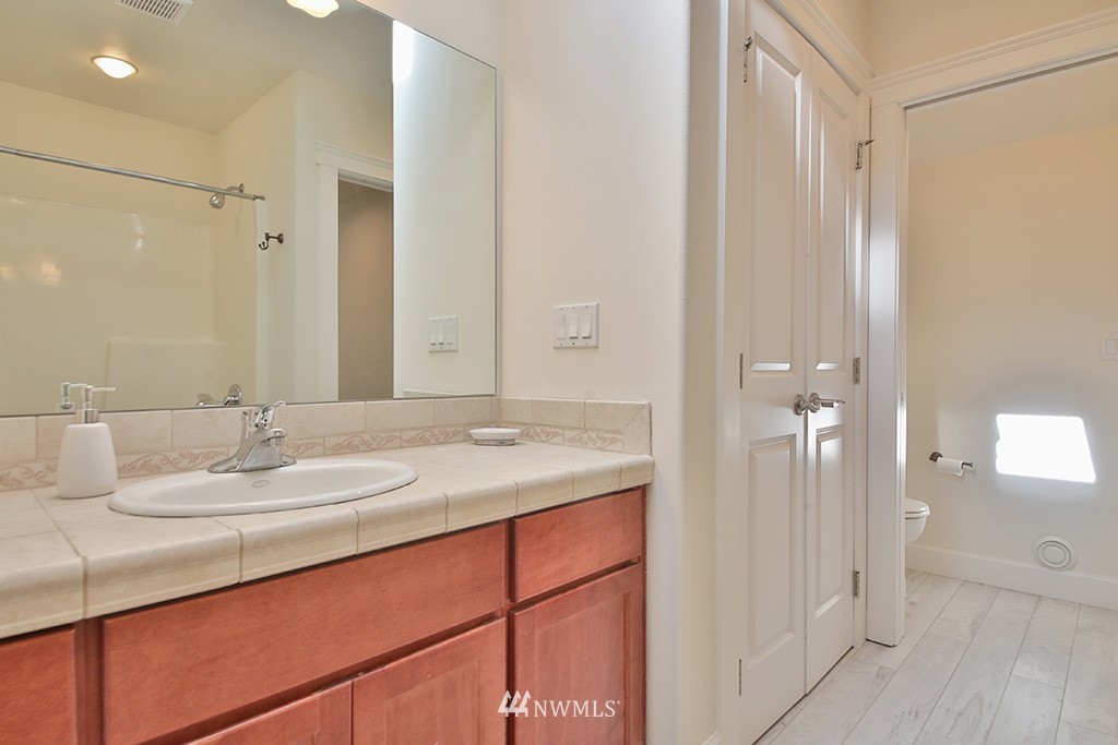 1822 East Watkins Road Freeland, WA 98249 - Photo 20 of 25 a bathroom with a granite countertop sink and a mirror