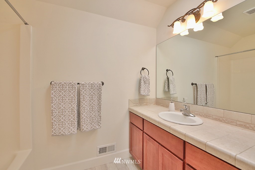 1822 East Watkins Road Freeland, WA 98249 - Photo 21 of 25 a bathroom with a sink vanity and a mirror