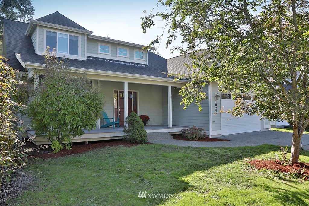 1822 East Watkins Road Freeland, WA 98249 - Photo 25 of 25 a front view of a house with a yard garage and outdoor seating