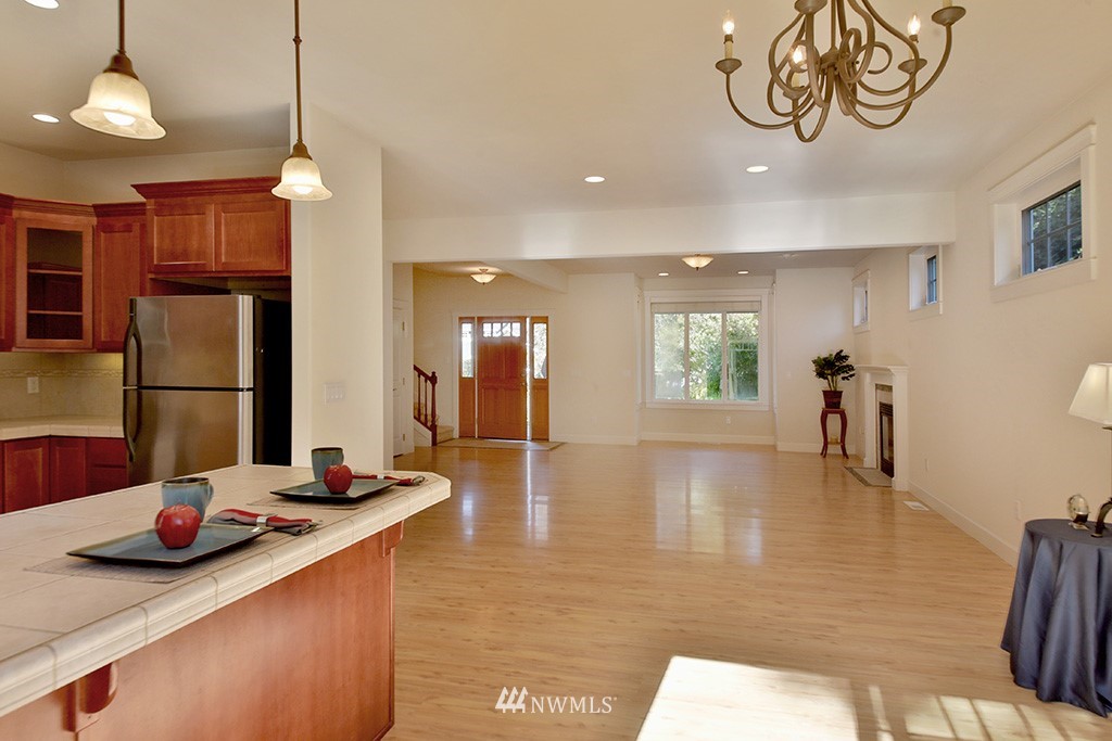 1822 East Watkins Road Freeland, WA 98249 - Photo 6 of 25 a view of a dining room and livingroom with furniture wooden floor a chandelier