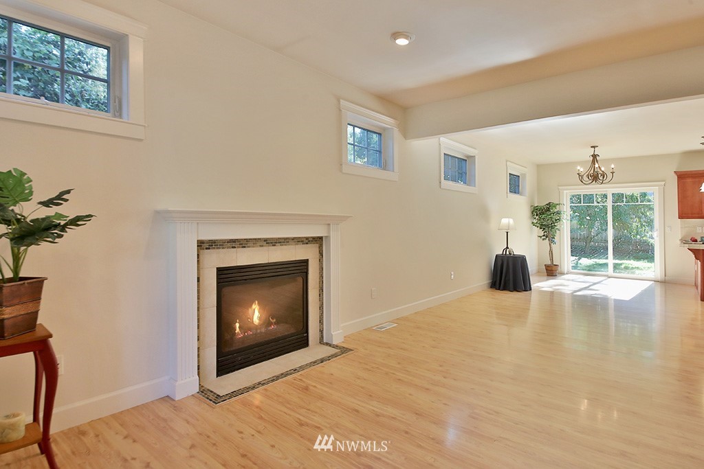 1822 East Watkins Road Freeland, WA 98249 - Photo 9 of 25 a view of an empty room with a fireplace and a window