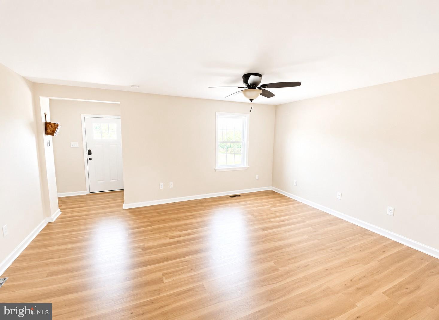 17854 Meriwether Lewis Street Ruther Glen, VA 22546 - Photo 10 of 35 a view of empty room with wooden floor and fan