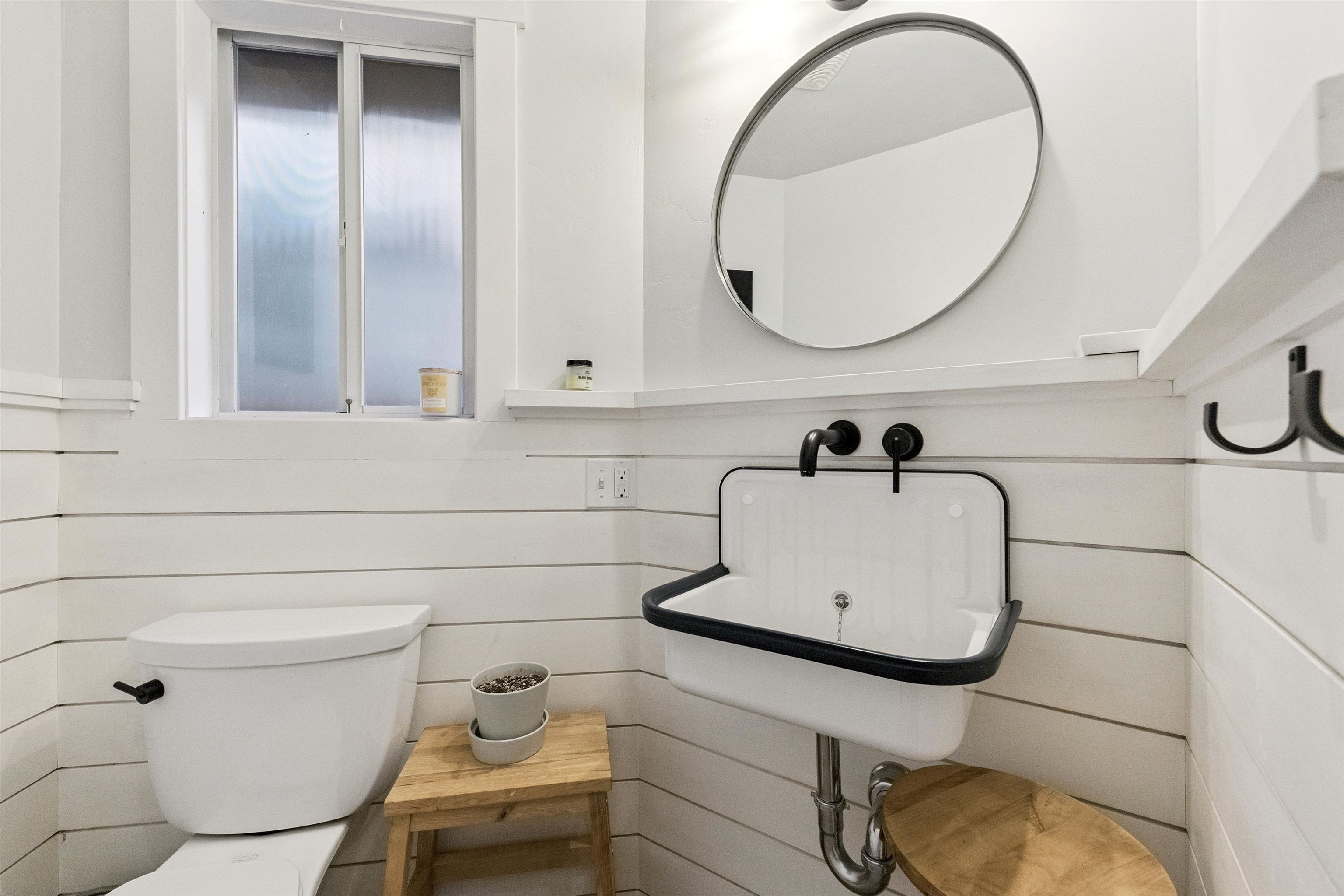 a bathroom with a sink mirror and toilet