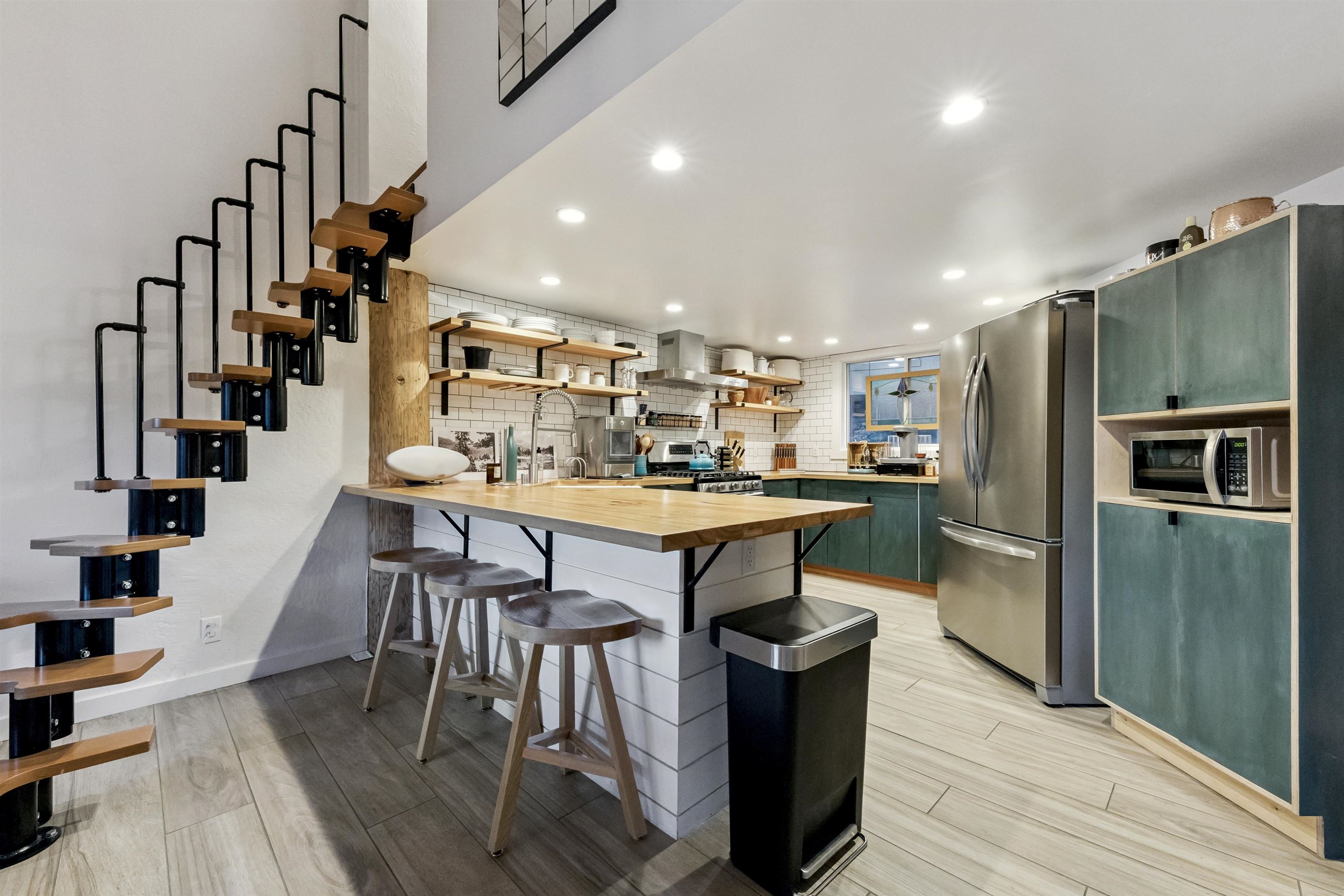 15462 Donner Pass Road, Unit 30 Truckee, CA 96161 - Photo 11 of 28 a kitchen with stainless steel appliances kitchen island granite countertop a table chairs and a refrigerator
