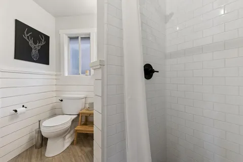 a bathroom with a toilet a sink and shower