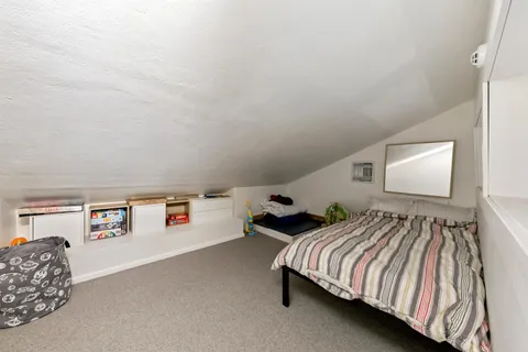 a bedroom with a bed and lamp