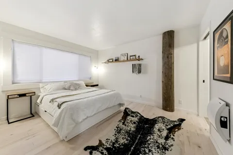 a bedroom with bed and a window