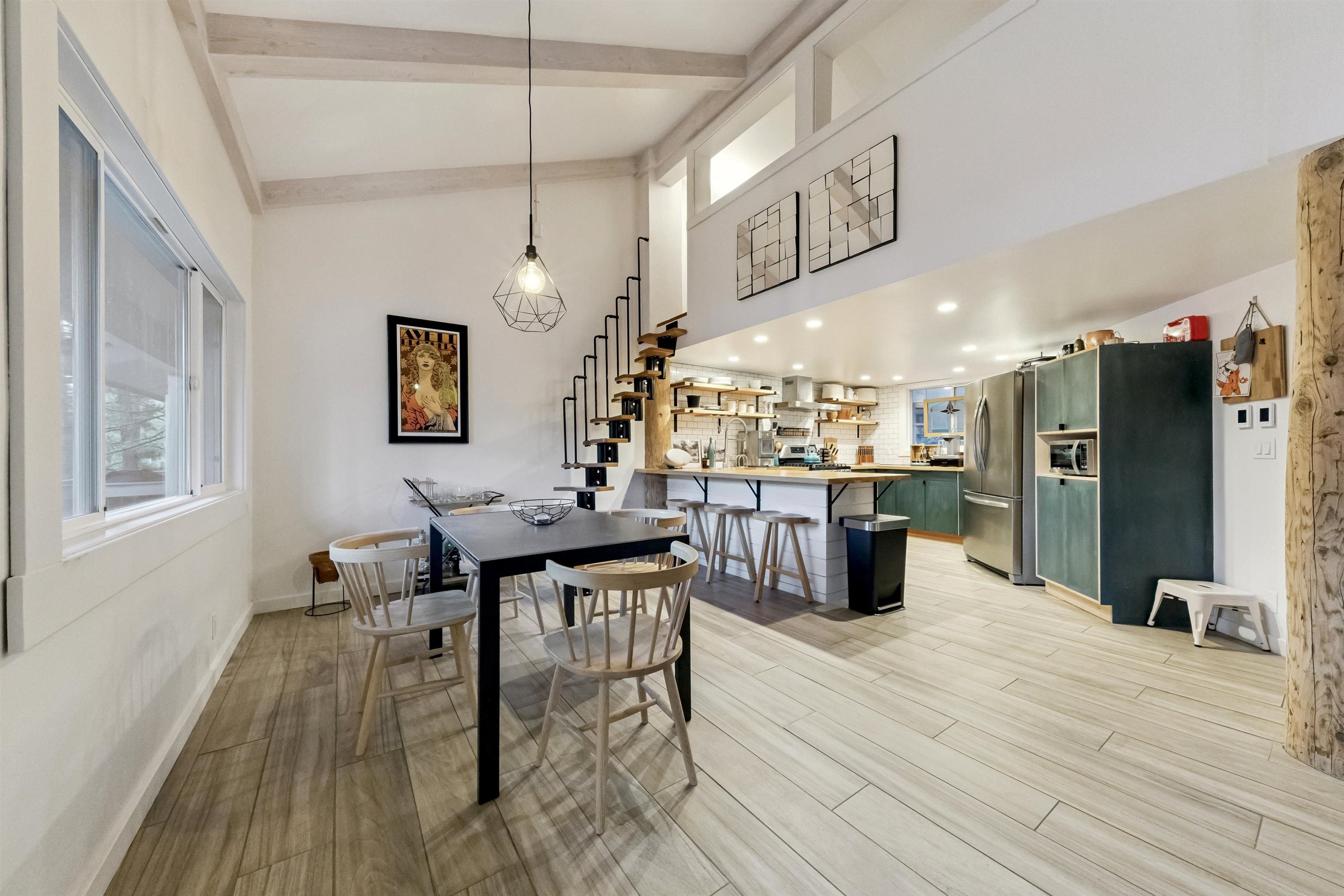 15462 Donner Pass Road, Unit 30 Truckee, CA 96161 - Photo 18 of 28 a kitchen with stainless steel appliances kitchen island granite countertop a table chairs and a refrigerator