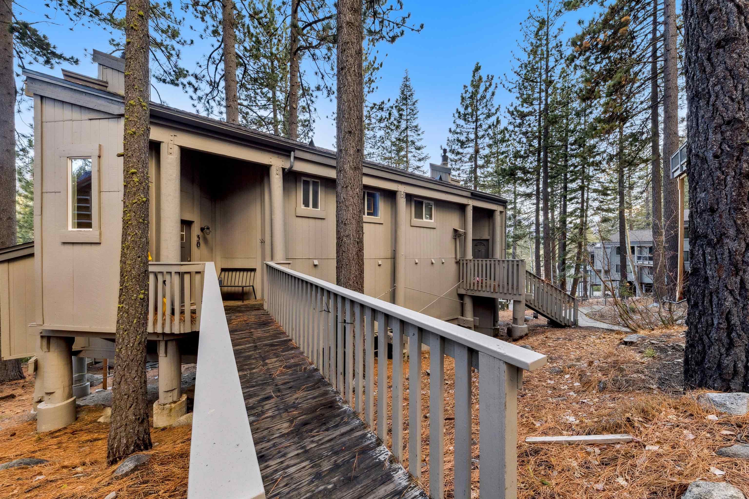 15462 Donner Pass Road, Unit 30 Truckee, CA 96161 - Photo 18 of 28 a view of a house with wooden deck and trees