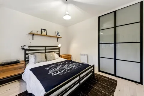 a bed sitting in a bedroom next to a window