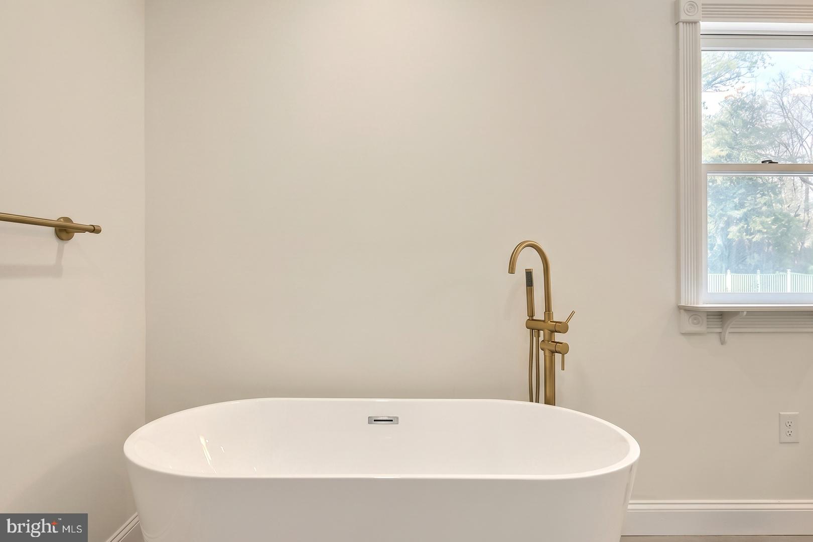 1070 Fish And Game Road East Berlin, PA 17316 - Photo 50 of 77 a white bath tub sitting in a bathroom next to a window