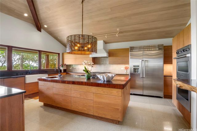 a kitchen with stainless steel appliances granite countertop a sink and refrigerator