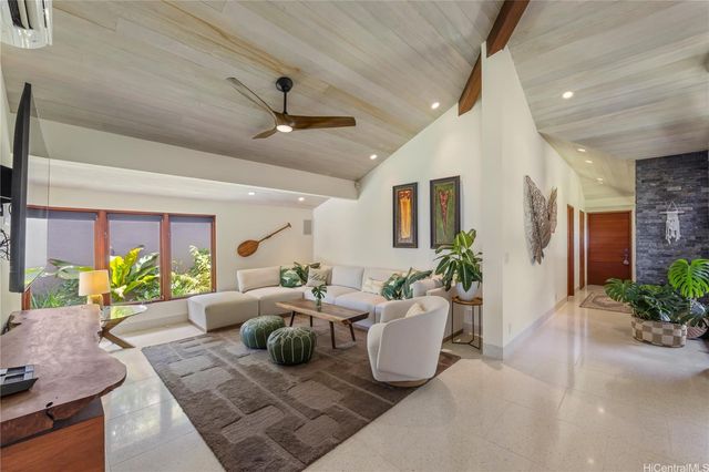 a living room with furniture potted plant and a window