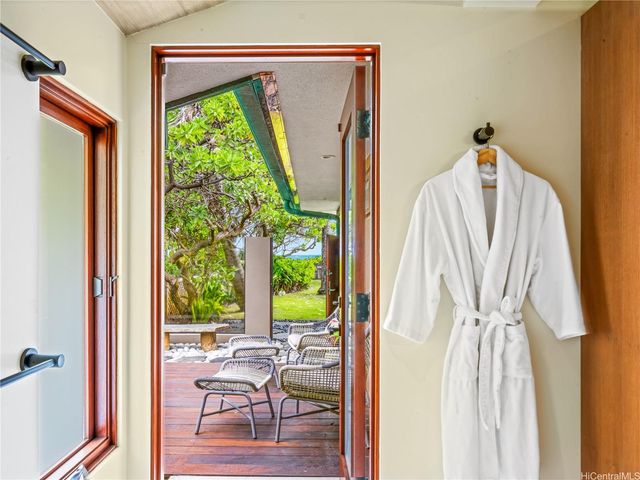 a view of a living room with a window and hardwood floor